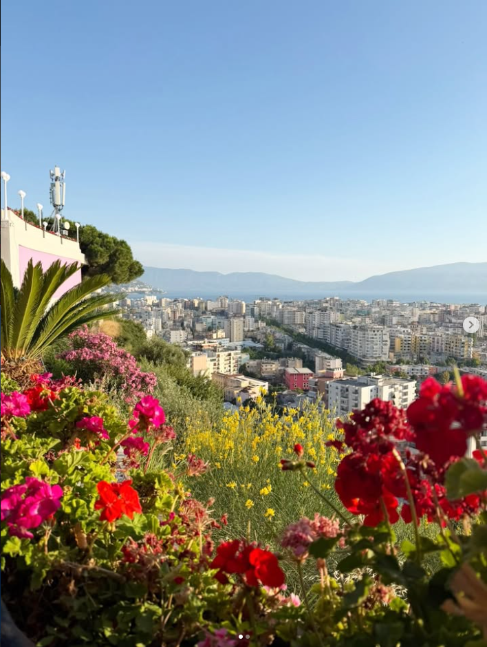 Panoramic view of Vlorë from Kuzum Baba terrace with flowers and the sea