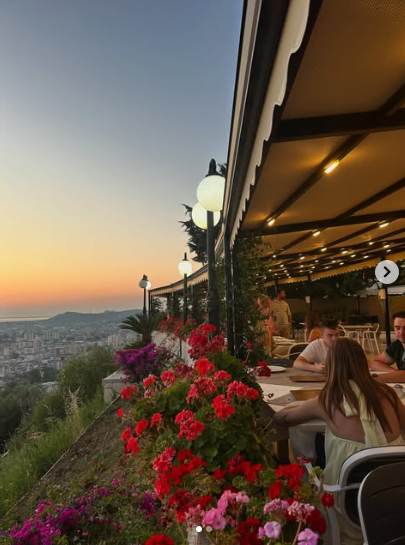 Terrace at dusk with lamp posts and string lights
